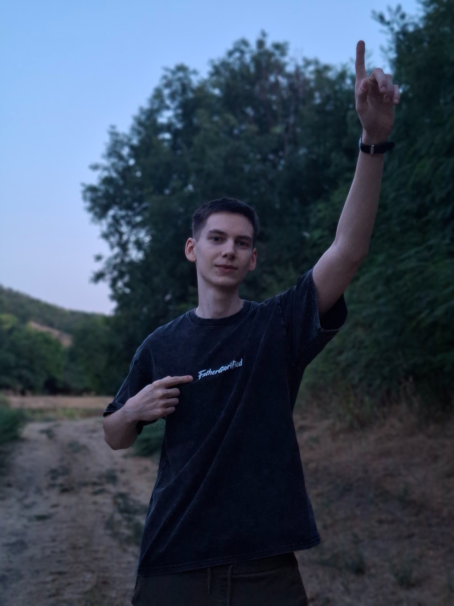 FatherGlorified tee worn outdoors, pointing upward